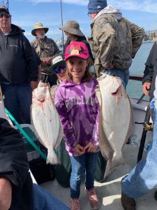 Child holding two fish