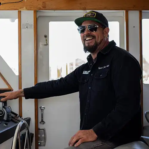 Man at controls of a boat